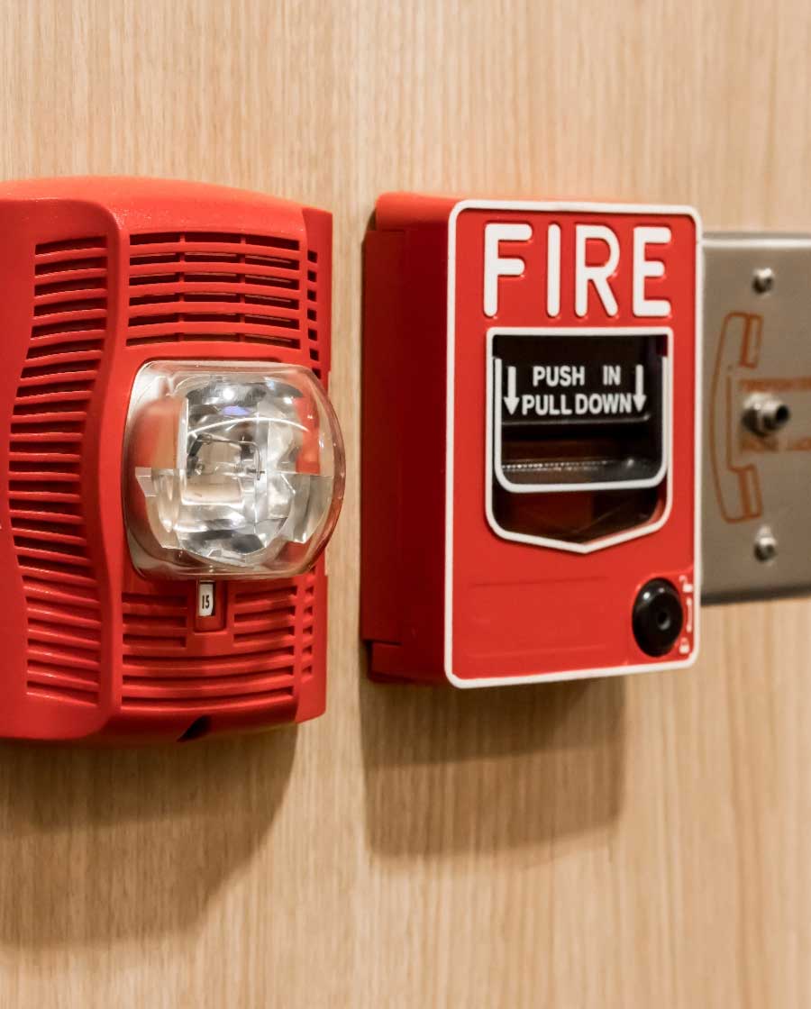 Fire alarm horn strobe and pull station on a wall